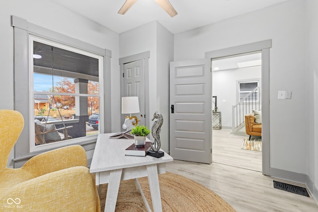 office space featuring ceiling fan and light wood-type flooring