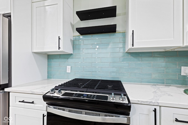 kitchen with tasteful backsplash, light stone counters, white cabinets, and stainless steel appliances