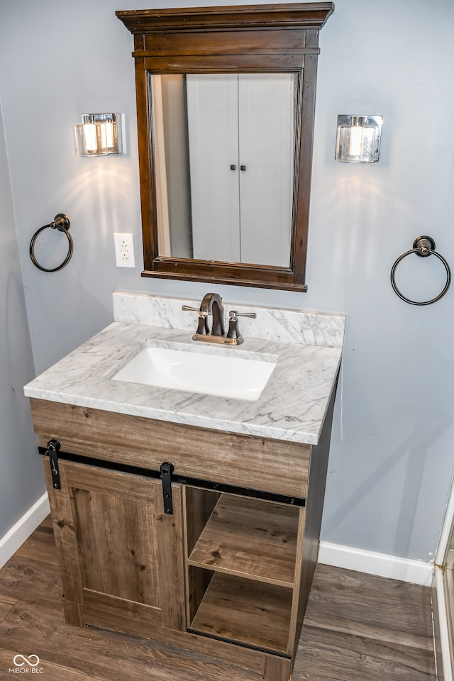 bathroom with vanity and wood-type flooring