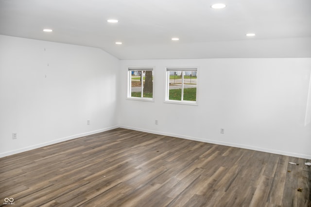 unfurnished room with dark hardwood / wood-style flooring and vaulted ceiling