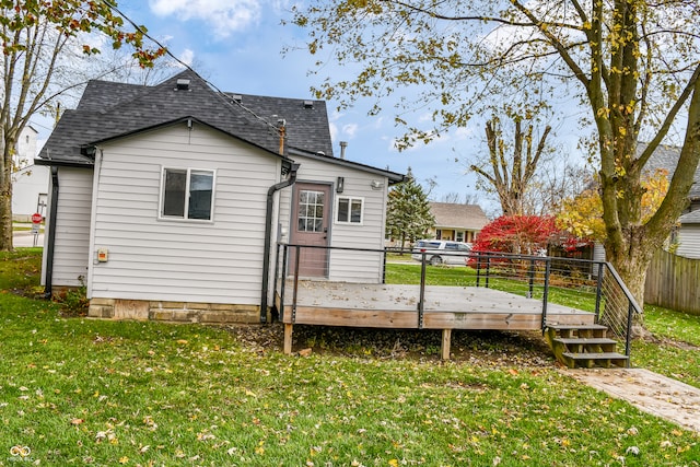 rear view of property with a lawn and a deck