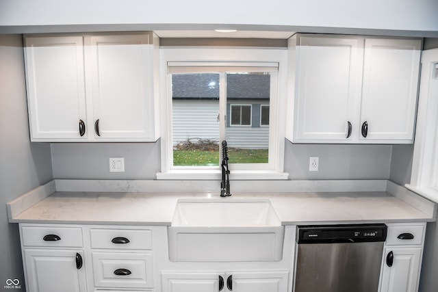 kitchen with dishwasher, white cabinets, and sink