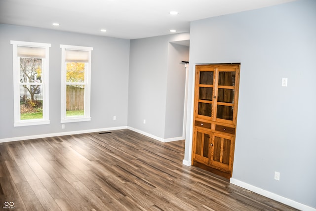 spare room with dark hardwood / wood-style floors