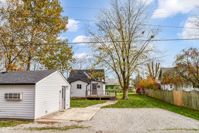 view of yard featuring a deck and an outdoor structure