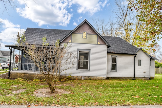 back of house with a lawn