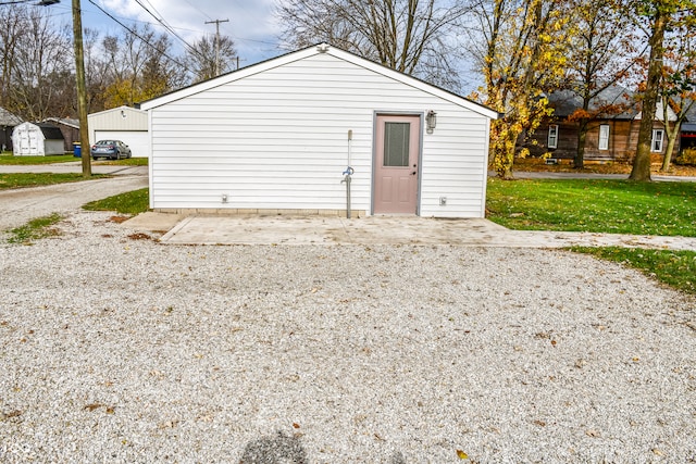 view of outbuilding featuring a yard