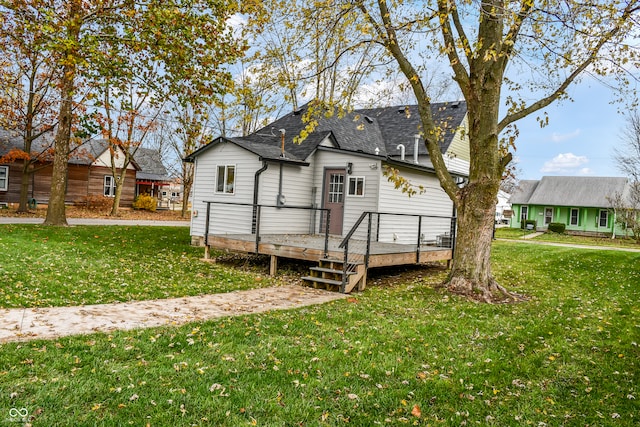 back of house featuring a yard and a wooden deck