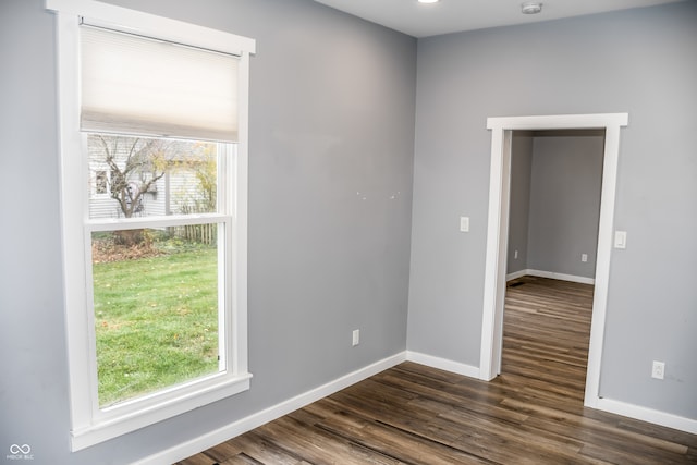 empty room featuring dark hardwood / wood-style floors and a wealth of natural light