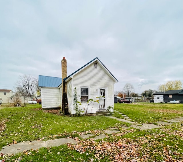 rear view of property with a lawn