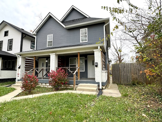 view of front facade with a front lawn and covered porch