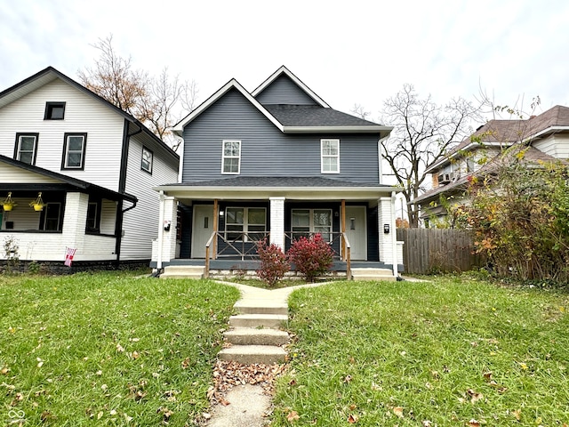 view of front of property featuring covered porch and a front yard