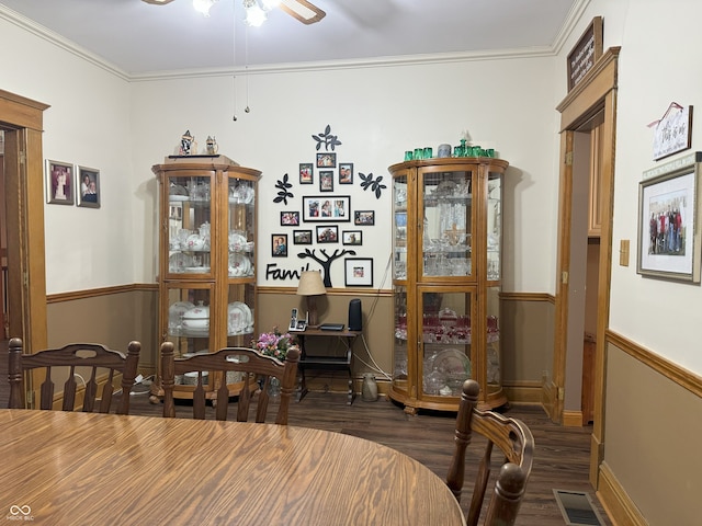 dining area featuring ceiling fan, crown molding, and dark wood-type flooring