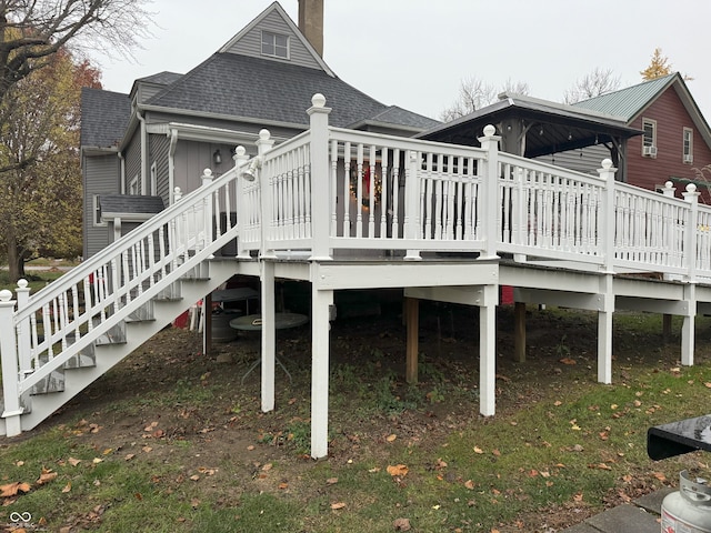 rear view of house featuring a wooden deck