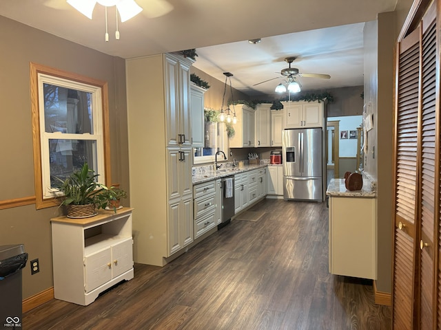 kitchen featuring ceiling fan, sink, hanging light fixtures, dark hardwood / wood-style floors, and appliances with stainless steel finishes