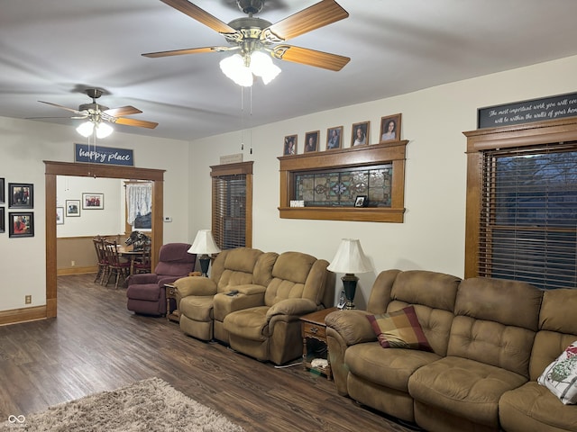 living room featuring ceiling fan and dark hardwood / wood-style floors