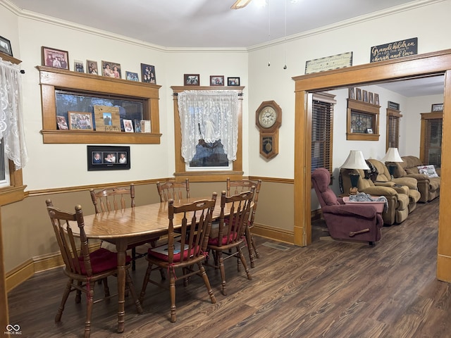 dining space featuring dark hardwood / wood-style flooring and crown molding