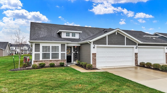 craftsman house with a front yard and a garage