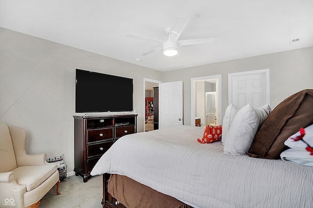 carpeted bedroom featuring ensuite bath and ceiling fan