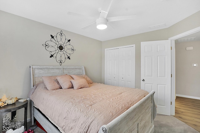 bedroom with hardwood / wood-style floors, a closet, and ceiling fan