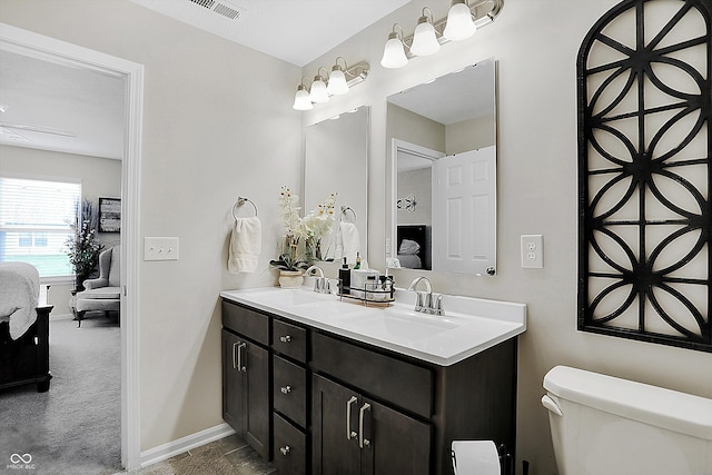 bathroom featuring vanity and toilet