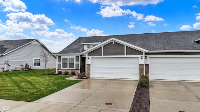 view of front of property featuring a garage and a front lawn