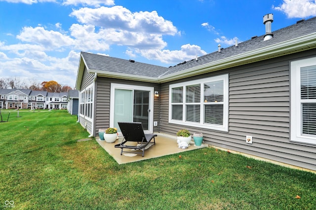 rear view of property with a lawn and a patio area