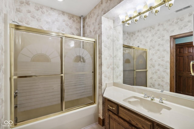 bathroom with shower / bath combination with glass door and vanity