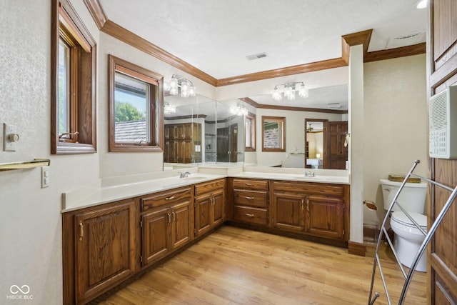 bathroom with vanity, hardwood / wood-style flooring, toilet, and ornamental molding