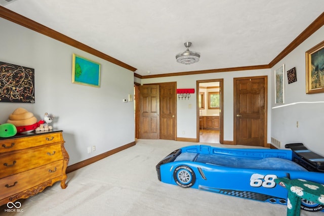 bedroom with carpet floors, ensuite bath, and ornamental molding