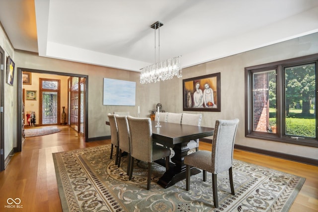 dining room with a chandelier and hardwood / wood-style flooring