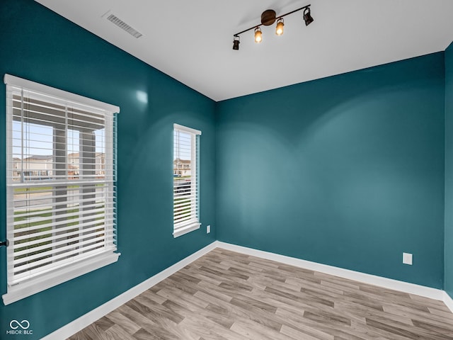 spare room featuring light hardwood / wood-style flooring