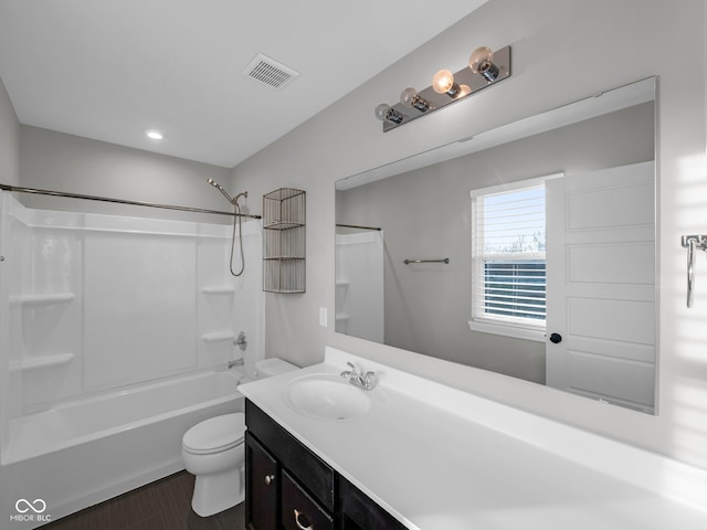 full bathroom with vanity, hardwood / wood-style floors, shower / bathing tub combination, and toilet