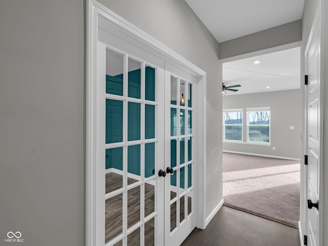 corridor featuring french doors and carpet