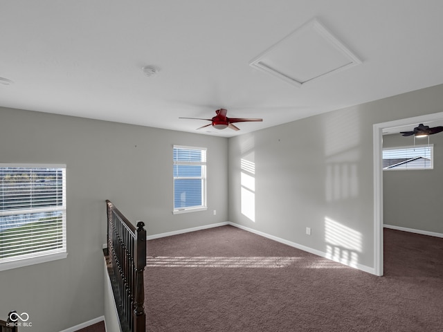 carpeted spare room with ceiling fan