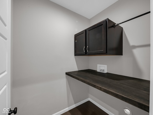 clothes washing area featuring cabinets, wood-type flooring, and hookup for a washing machine