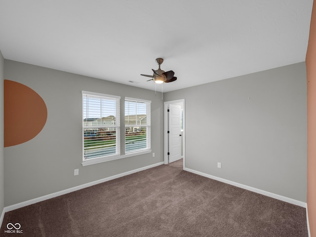 carpeted spare room with ceiling fan