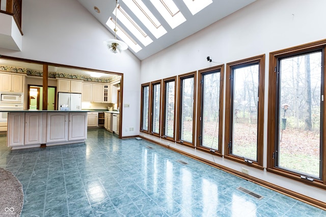 4257 Tattersall Dr, Plainfield, IN 46168 - unfurnished living room featuring a skylight, high vaulted ceiling, and baseboards