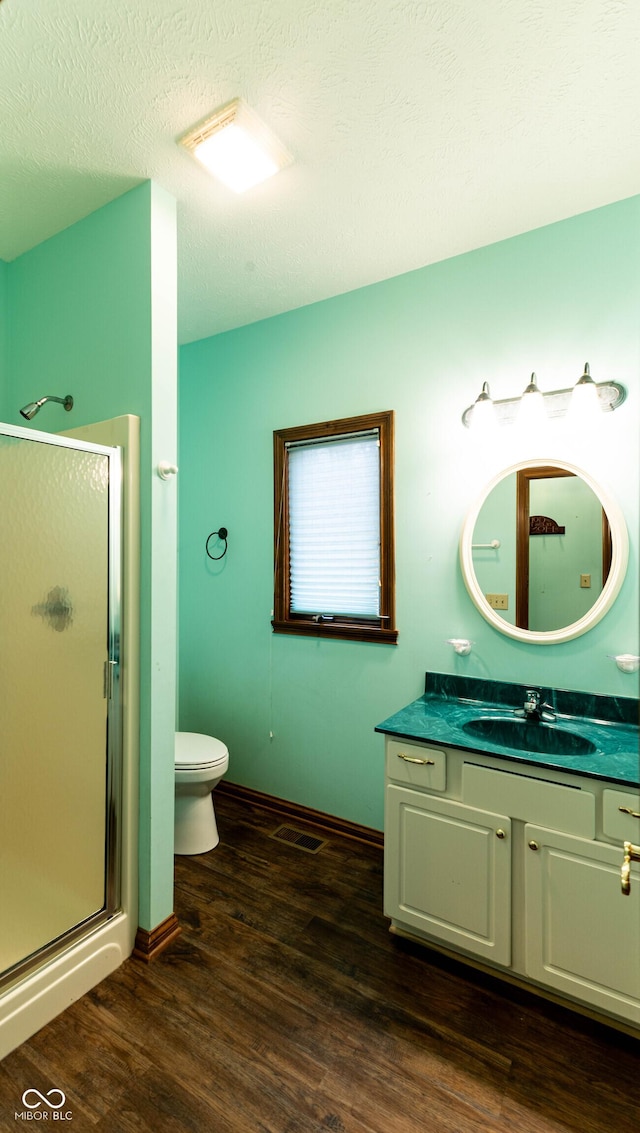 4257 Tattersall Dr, Plainfield, IN 46168 - full bathroom with a stall shower, vanity, toilet, wood finished floors, and baseboards