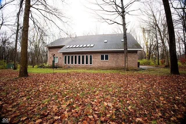 back of property featuring solar panels