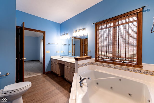 4257 Tattersall Dr, Plainfield, IN 46168 - bathroom with a tub with jets, vanity, toilet, wood finished floors, and plenty of natural light