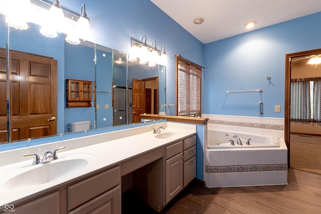 4257 Tattersall Dr, Plainfield, IN 46168 - bathroom with a garden tub, toilet, double vanity, and wood finished floors