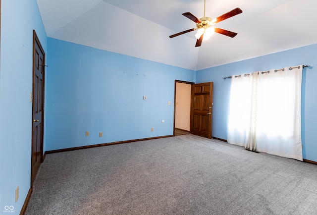 empty room with carpet floors, vaulted ceiling, and ceiling fan