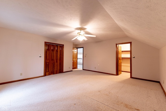 4257 Tattersall Dr, Plainfield, IN 46168 - unfurnished bedroom featuring light colored carpet, a closet, a textured ceiling, baseboards, and lofted ceiling