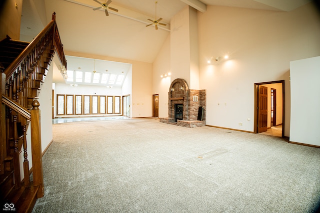 unfurnished living room featuring carpet flooring, a brick fireplace, and high vaulted ceiling