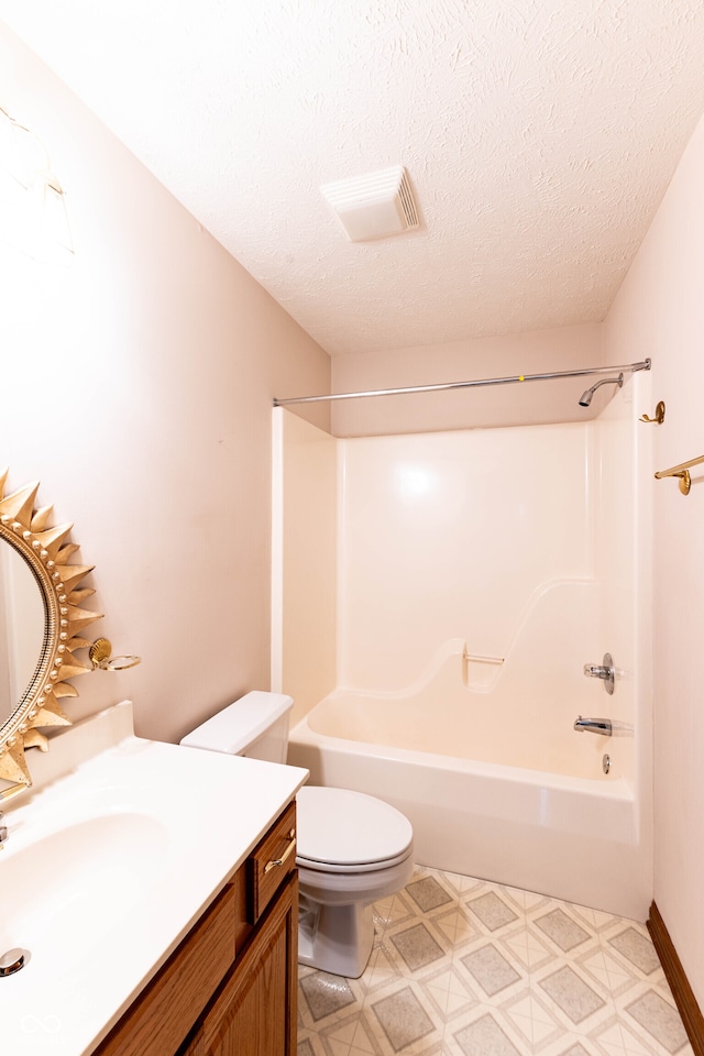 full bathroom with vanity, a textured ceiling, toilet, and  shower combination