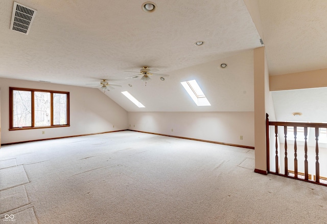 4257 Tattersall Dr, Plainfield, IN 46168 - additional living space featuring carpet flooring, a skylight, lofted ceiling, baseboards, and ceiling fan