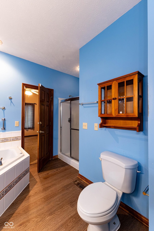 4257 Tattersall Dr, Plainfield, IN 46168 - full bathroom with a shower stall, a garden tub, toilet, wood finished floors, and a textured ceiling