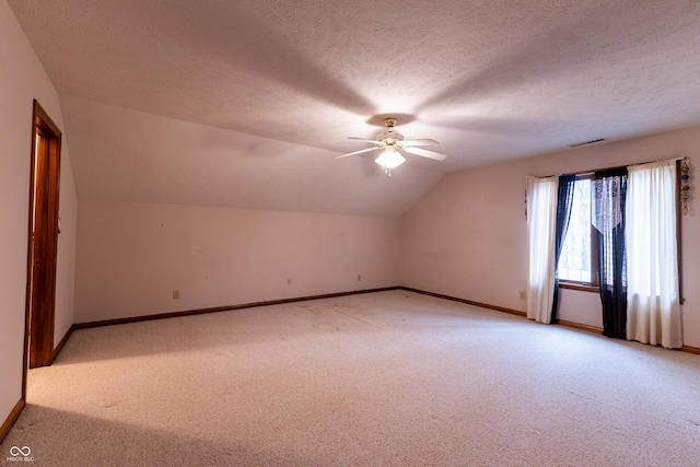 4257 Tattersall Dr, Plainfield, IN 46168 - additional living space featuring light colored carpet, a ceiling fan, vaulted ceiling, baseboards, and a textured ceiling
