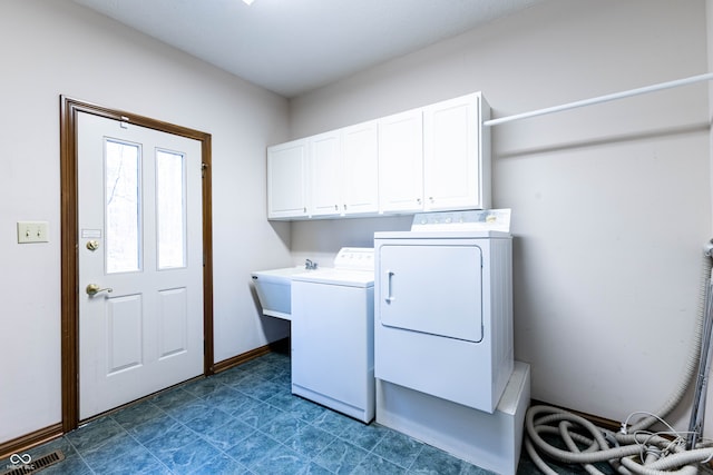 laundry room with cabinets, independent washer and dryer, and sink