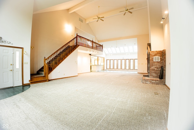 unfurnished living room featuring carpet flooring, ceiling fan, beam ceiling, and high vaulted ceiling